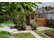 A cozy backyard with a small patio, garden beds, and a well-kept lawn area at 461 S Sherman St, Denver, CO 80209