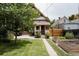 Charming backyard featuring a garden, patio, and a well-maintained lawn at 461 S Sherman St, Denver, CO 80209