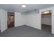 Unfinished basement featuring gray carpet, white walls, visible ductwork, and doorways to additional spaces at 461 S Sherman St, Denver, CO 80209