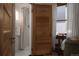 Ensuite bathroom featuring a sleek walk-in shower, stylish lighting, and an adjacent bedroom with a light-filled window at 461 S Sherman St, Denver, CO 80209