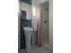 Bright bathroom featuring a standing sink, blue accent tiles, and modern fixtures at 461 S Sherman St, Denver, CO 80209