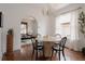 Bright dining room with modern chandelier, hardwood floors, and view to living room at 461 S Sherman St, Denver, CO 80209