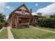 Inviting exterior showcasing the home's brick facade, landscaped lawn, and driveway at 461 S Sherman St, Denver, CO 80209