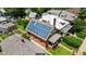 Aerial shot of a two-story brick home fitted with solar panels on a tree-lined residential street at 461 S Sherman St, Denver, CO 80209