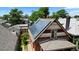 Angled view of a two-story brick home with a roof fitted with solar panels in a tree-lined neighborhood at 461 S Sherman St, Denver, CO 80209