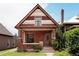 Charming brick home with a covered front porch, decorative roof, and well-maintained landscaping at 461 S Sherman St, Denver, CO 80209