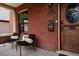 Charming front porch features black chairs, brick detail, and a decorative wooden door, adding character to the entryway at 461 S Sherman St, Denver, CO 80209