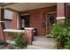 Covered brick front porch with elegant wood door and well-maintained landscaping at 461 S Sherman St, Denver, CO 80209