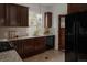 A functional kitchen featuring wood cabinets, a corner sink, and a view to the outdoors at 461 S Sherman St, Denver, CO 80209