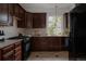 Well-equipped kitchen featuring dark wood cabinets, modern appliances, and tile flooring at 461 S Sherman St, Denver, CO 80209