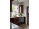 Charming kitchen featuring granite countertops, dark wood cabinetry, and natural light from a large window at 461 S Sherman St, Denver, CO 80209