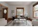 Bright living room showcasing an area rug, large windows, and stylish decor, creating a cozy atmosphere at 461 S Sherman St, Denver, CO 80209