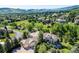 Aerial view of a luxury home nestled among trees with a curved driveway and manicured landscaping at 16134 Sandstone Dr, Morrison, CO 80465