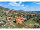 Houses nestled in a scenic landscape with mountains and stunning rock formations at 16134 Sandstone Dr, Morrison, CO 80465