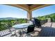 A covered balcony with outdoor dining area and mountain views at 16134 Sandstone Dr, Morrison, CO 80465