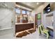 Well-lit bathroom featuring dual sinks, glass shower, and contemporary decor at 16134 Sandstone Dr, Morrison, CO 80465