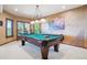 Billiards room featuring a pool table and decorative brick wall at 16134 Sandstone Dr, Morrison, CO 80465