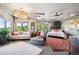 Bright main bedroom boasts ample natural light, seating area, and tray ceilings at 16134 Sandstone Dr, Morrison, CO 80465