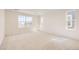 Bright and airy bedroom featuring neutral carpeting and large windows for plenty of natural light at 2138 S Haleyville Way, Aurora, CO 80018