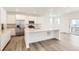 Modern kitchen with stainless steel appliances, white cabinets, and a large center island at 2138 S Haleyville Way, Aurora, CO 80018