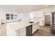 Bright kitchen with a large island, stainless steel dishwasher, and open floor plan at 2138 S Haleyville Way, Aurora, CO 80018