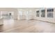 Spacious living area featuring hardwood floors and multiple windows for ample sunlight at 2138 S Haleyville Way, Aurora, CO 80018