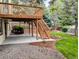 Spacious backyard featuring a wooden deck and mature trees at 5814 Cole Way, Arvada, CO 80004