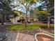 Beautifully landscaped backyard with mature trees and a wooden deck at 5814 Cole Way, Arvada, CO 80004