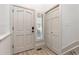 Bright hallway featuring light wood floors, a paneled front door and access to a closet at 5814 Cole Way, Arvada, CO 80004