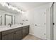 Bathroom featuring dual sinks with vanity and shower at 8785 Whiteclover St, Littleton, CO 80125