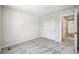 This bedroom view showcases neutral walls and flooring, closet, and ensuite access to the bathroom at 8785 Whiteclover St, Littleton, CO 80125