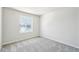Bright bedroom features neutral walls, carpeted floors, and a large window with neighborhood views at 8785 Whiteclover St, Littleton, CO 80125