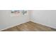 Empty bedroom with hardwood floors, a large window, and neutral-colored walls at 8785 Whiteclover St, Littleton, CO 80125