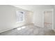 Empty bedroom with plush carpet and a large window at 8785 Whiteclover St, Littleton, CO 80125