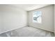 The bright bedroom features neutral walls, carpeted floors, and a large window with neighborhood views at 8785 Whiteclover St, Littleton, CO 80125