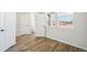 Bright bedroom features hardwood floors, three windows, and white trim at 8785 Whiteclover St, Littleton, CO 80125