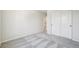 The bedroom has neutral walls and flooring with a double door closet and ensuite access to the bathroom at 8785 Whiteclover St, Littleton, CO 80125