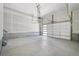 Spacious two-car garage with concrete floors and a modern, partially frosted glass garage door at 8785 Whiteclover St, Littleton, CO 80125