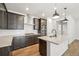 Well-lit kitchen showcasing stainless steel appliances, an island with a sink, and tiled backsplash at 8785 Whiteclover St, Littleton, CO 80125
