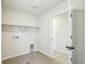 The functional laundry room has tile floors, utility sink hook-ups, and plenty of storage space at 8785 Whiteclover St, Littleton, CO 80125