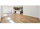 Open-concept living room showcases hardwood floors with a kitchen island and modern lighting at 8785 Whiteclover St, Littleton, CO 80125
