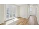 Bright living room with sliding glass doors to a balcony and hardwood floors at 8785 Whiteclover St, Littleton, CO 80125