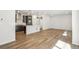 Open-concept living space with modern kitchen, stainless steel appliances, and hardwood floors at 8785 Whiteclover St, Littleton, CO 80125