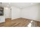 Open living area featuring hardwood floors, recessed lighting and adjacent kitchen space at 8785 Whiteclover St, Littleton, CO 80125