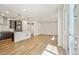 Bright open-concept living space with modern kitchen, hardwood floors and sliding door access at 8785 Whiteclover St, Littleton, CO 80125