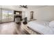A bright bedroom featuring hard wood floors, a window, and a ceiling fan at 5072 Cathay St, Denver, CO 80249
