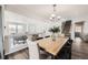 Open-concept dining room with stylish chandelier and views of the living area at 5072 Cathay St, Denver, CO 80249