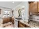 The Kitchen features granite countertops and modern stainless steel appliances at 5072 Cathay St, Denver, CO 80249