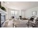 Bright living room with a fireplace, stylish decor, and hardwood floors at 5072 Cathay St, Denver, CO 80249