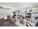 Bright living room with a fireplace, stylish decor, and hardwood floors at 5072 Cathay St, Denver, CO 80249
